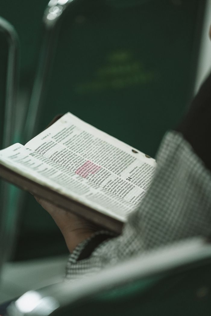 Person holding a Bible during a religious study session in West Java, Indonesia.